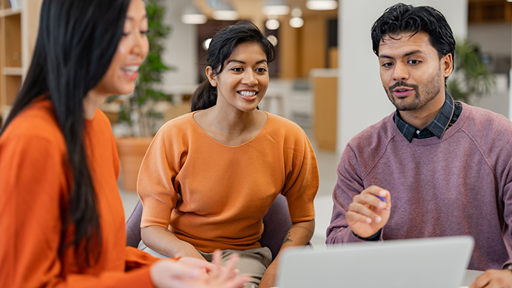 people in corporate office using laptop working together