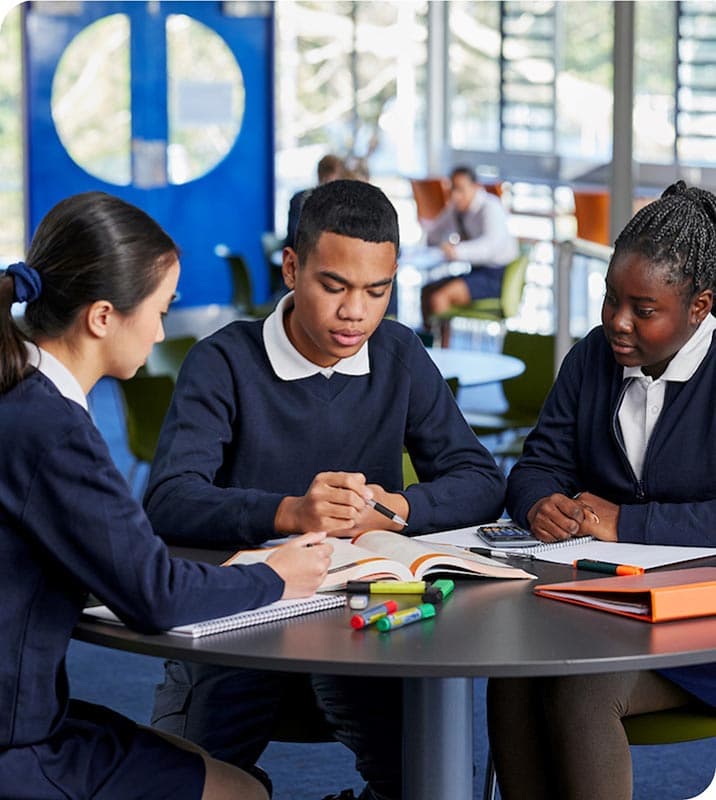 Students sitting around a table completing group work