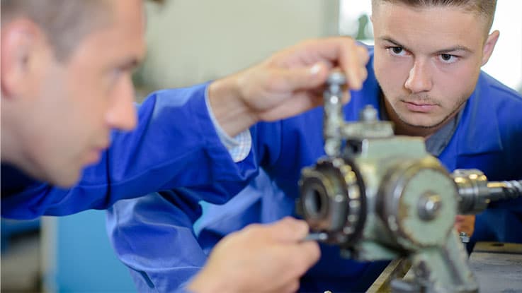 Boy working on a mechanical tool