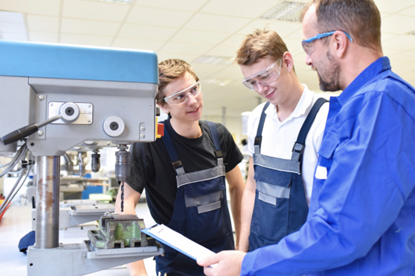 teens at woodwork machine