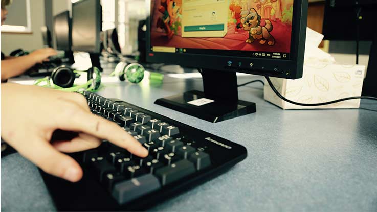 Student typing on keyboard