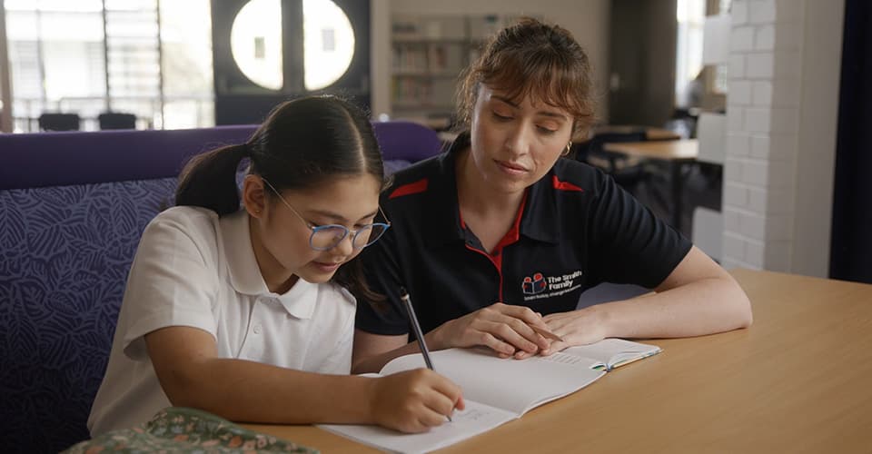 student gets homework help in a school library